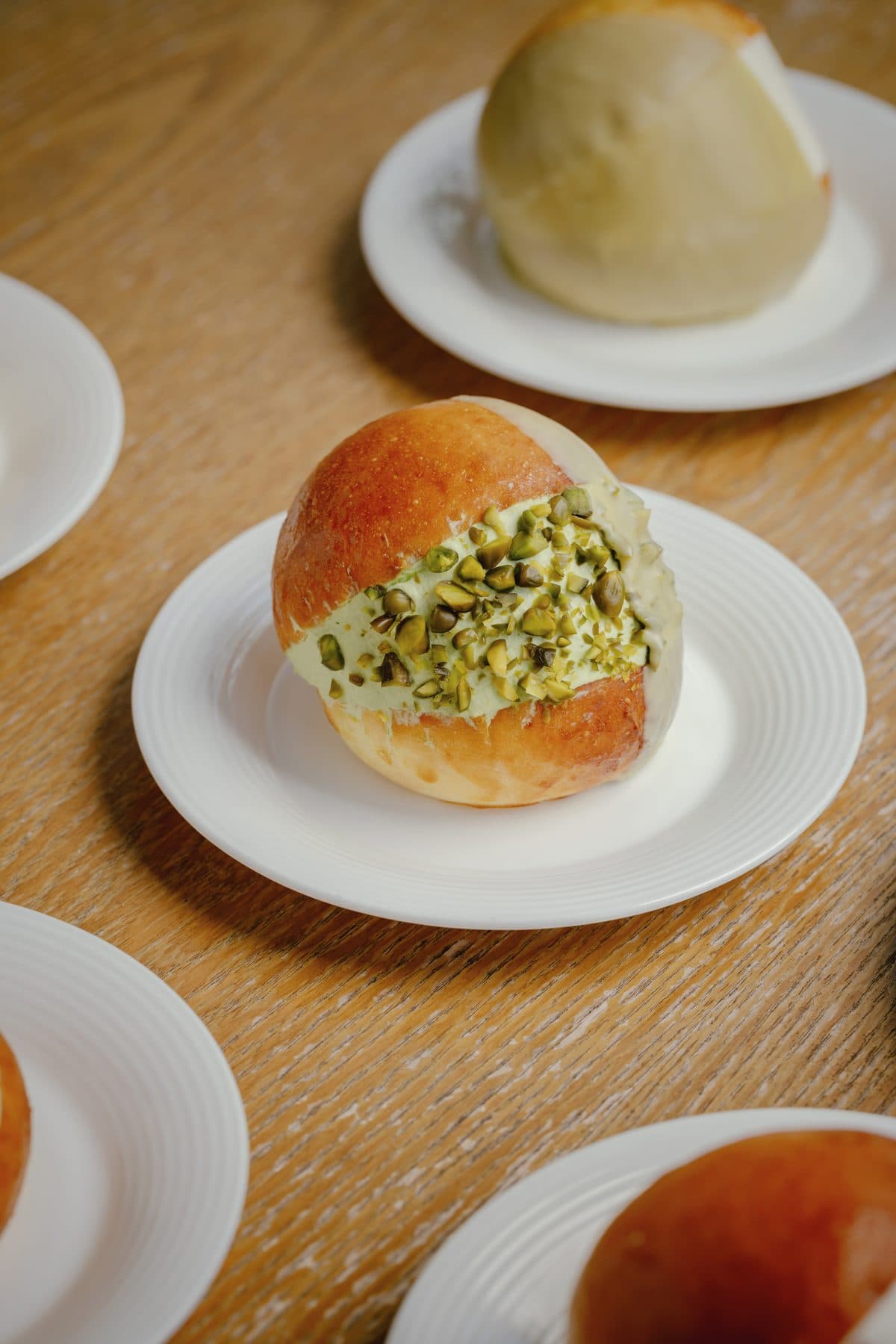 Maritozzo Pistacchio — Brioche, sweet cream, and a generous lid of slivered Bronte pistachios.