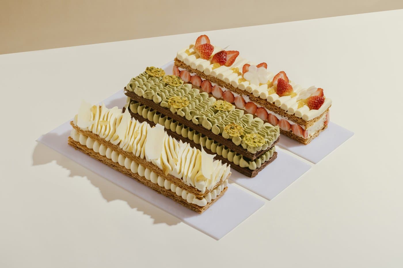 Mille-Feuille al Pistacchio — Caramelised puff pastry layered with vanilla, pistachio, or strawberry crémeux.