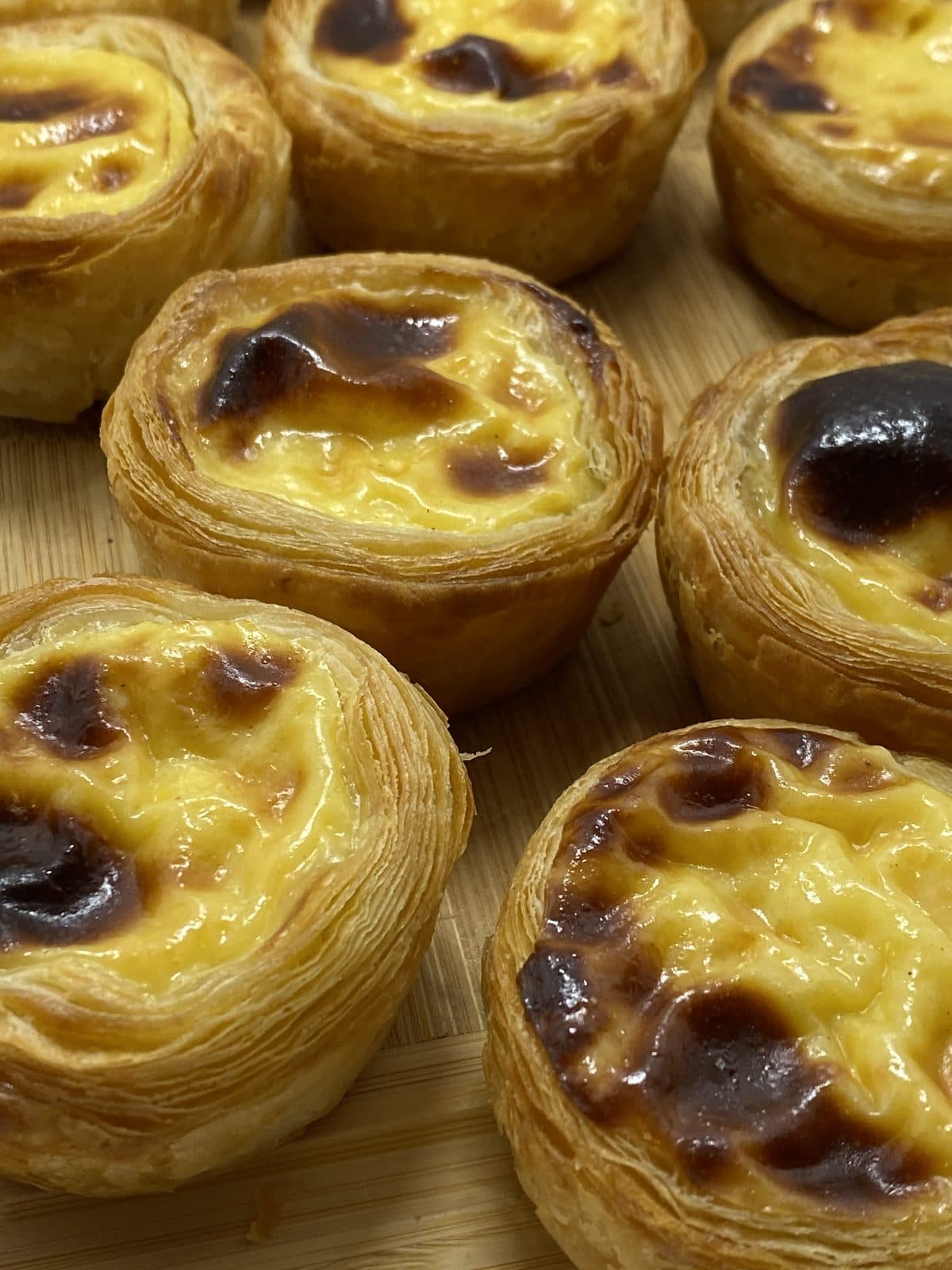 Pastel de Nata — Blistered top, set custard, hand-rolled puff. Best eaten warm at the counter.