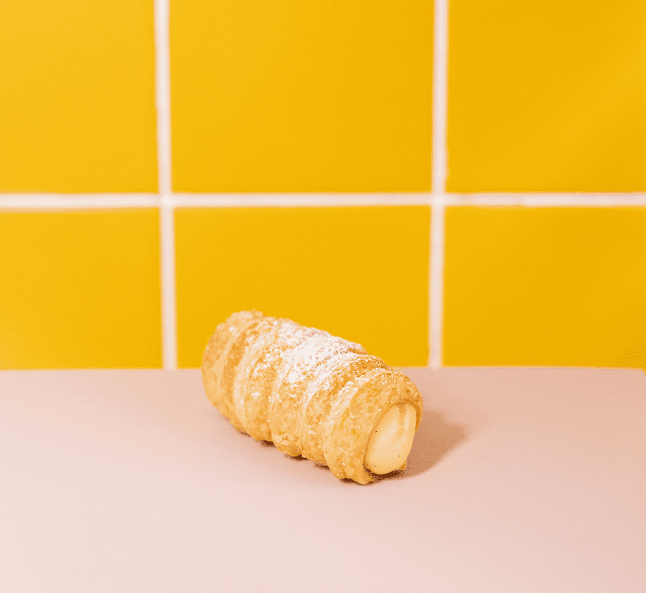 Cannoncino with custard — A crisp Italian pastry filled with silky custard, inspired by the comfort of a classic egg tart but finished with Sugar Daddy flair. Golden, creamy, and made to disappear in two bites.